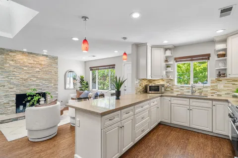 a kitchen with a sink stove and cabinets