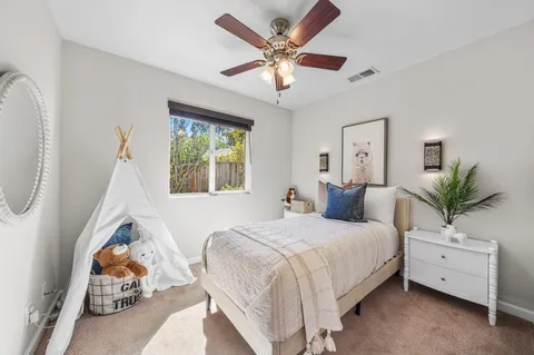 a spacious bedroom with a bed and a chandelier