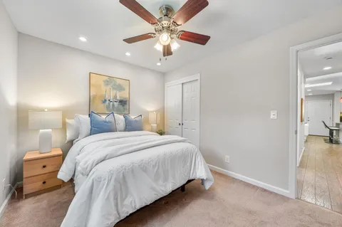a bedroom with a large bed and a chandelier