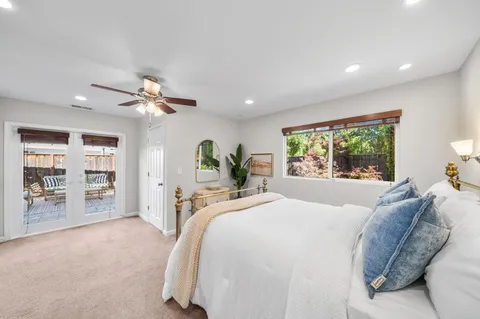 a spacious bedroom with a bed and a window