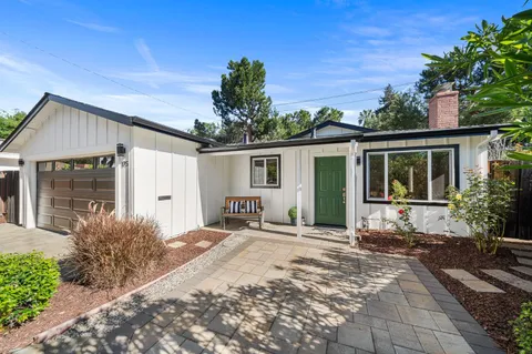 a front view of a house with a yard and a garage