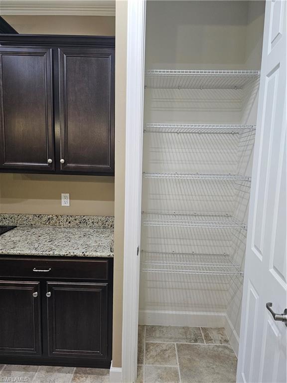 10840 Rutherford Road Fort Myers, FL 33913 - Photo 20 of 35 Clothes washing area featuring cabinets, washer and clothes dryer, and light tile patterned floors