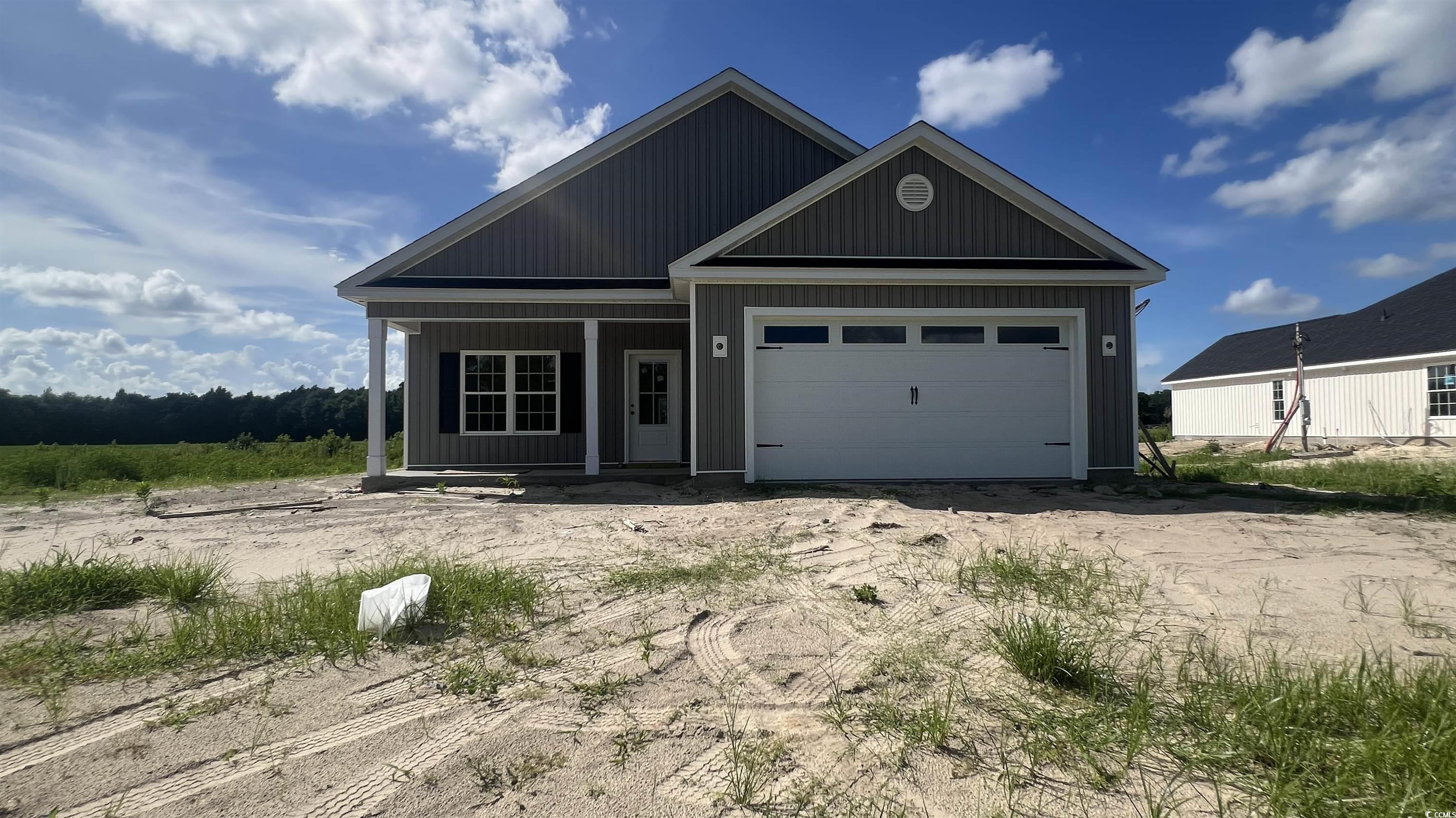3597 Valley Forge Road Aynor, SC 29511 - Photo 2 of 31 View of front of house with a porch, an attached garage, and driveway