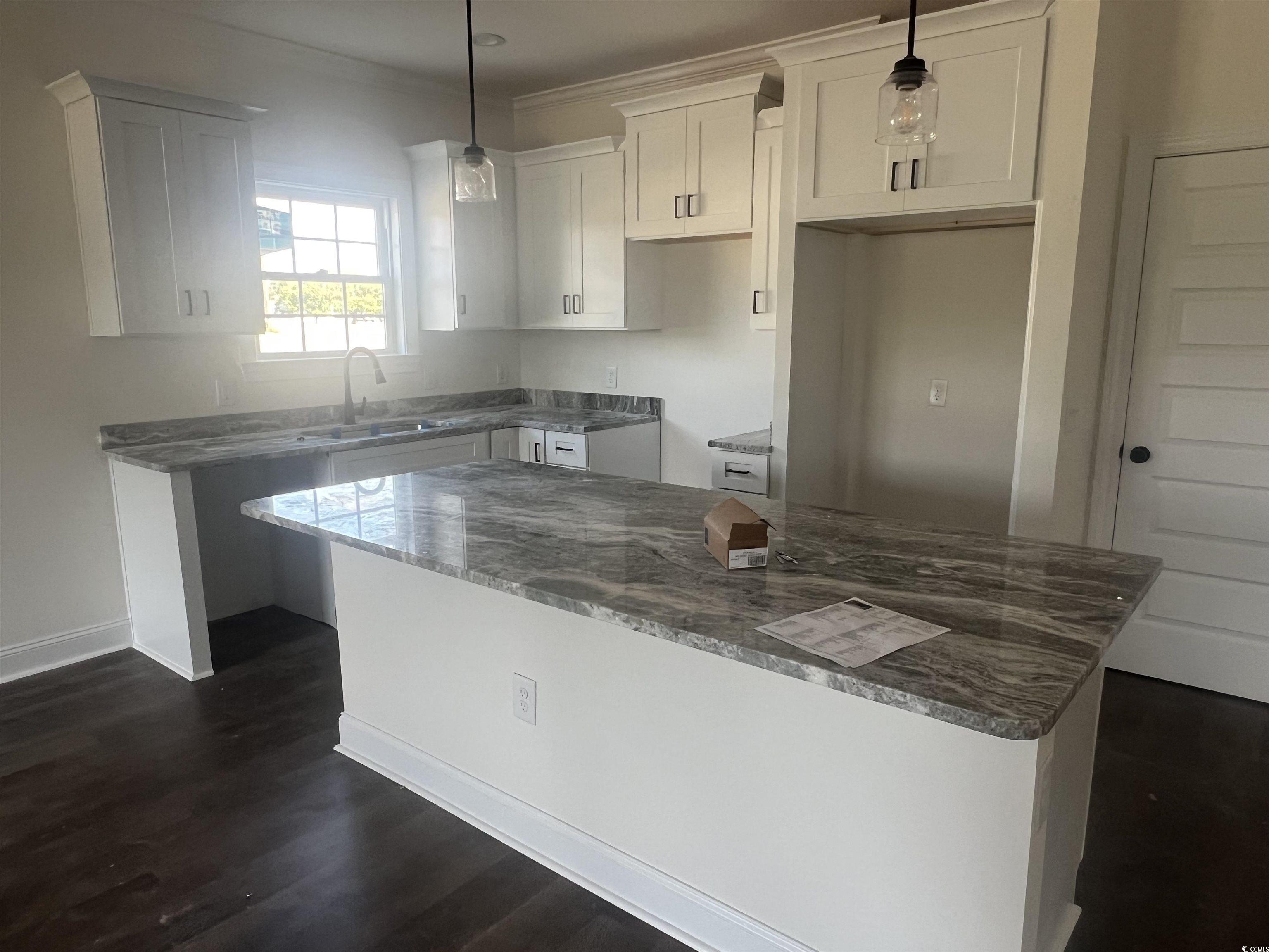 3597 Valley Forge Road Aynor, SC 29511 - Photo 22 of 31 Kitchen with a center island, decorative light fixtures, dark stone countertops, and dark wood-style floors