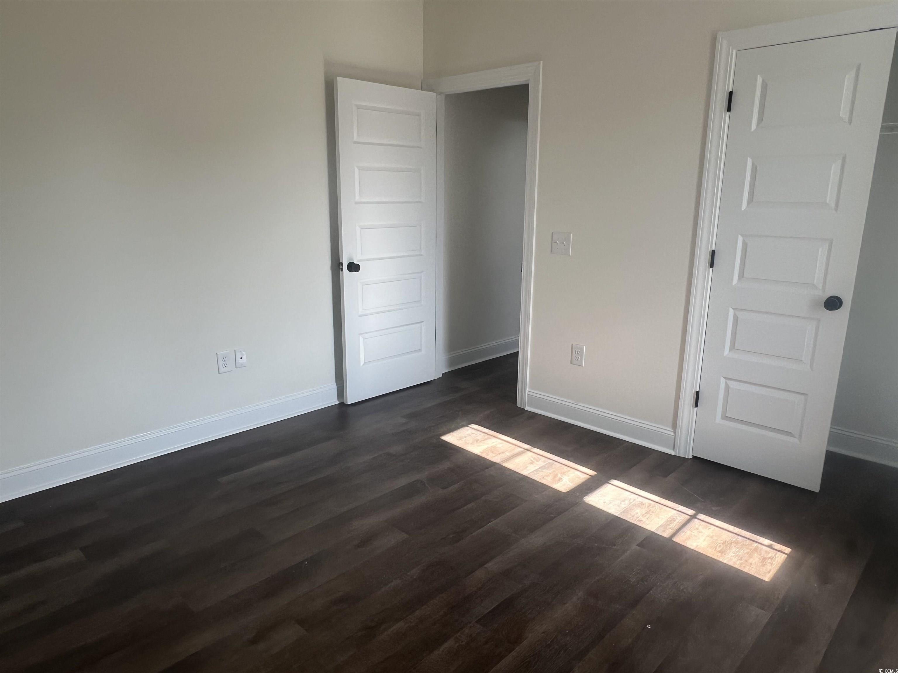 3597 Valley Forge Road Aynor, SC 29511 - Photo 28 of 31 Unfurnished bedroom featuring baseboards and dark wood-style floors