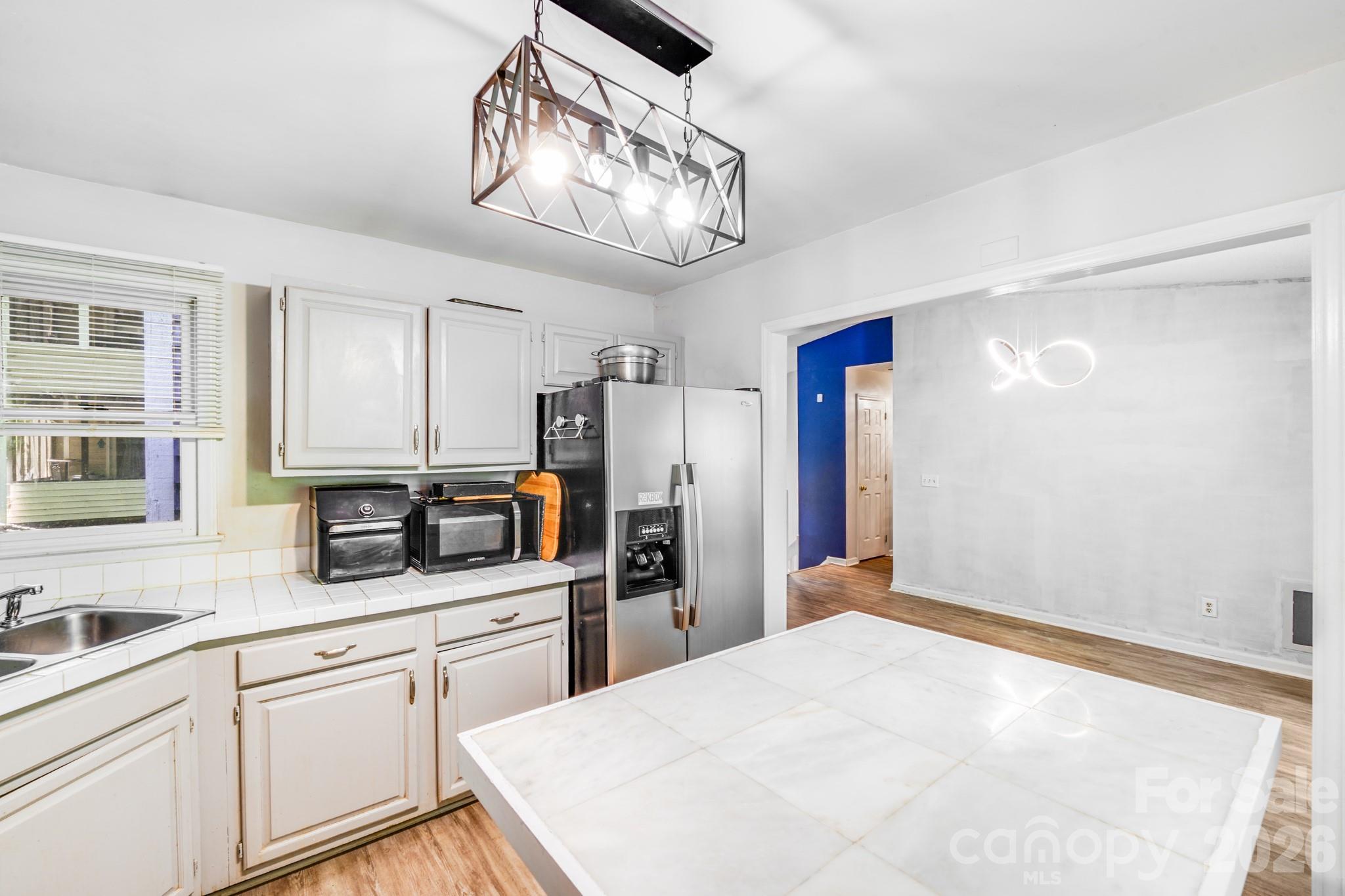 2116 Bon Villa Way Fort Mill, SC 29708 - Photo 11 of 28 a kitchen with stainless steel appliances a refrigerator sink and cabinets