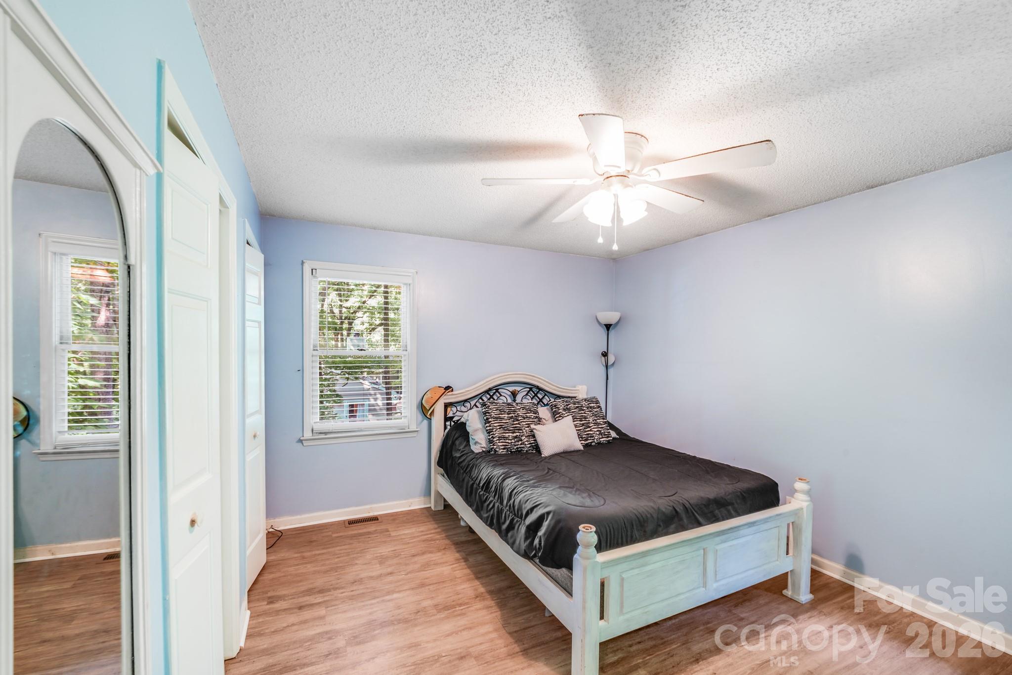 2116 Bon Villa Way Fort Mill, SC 29708 - Photo 14 of 28 a bedroom with a bed and a chandelier