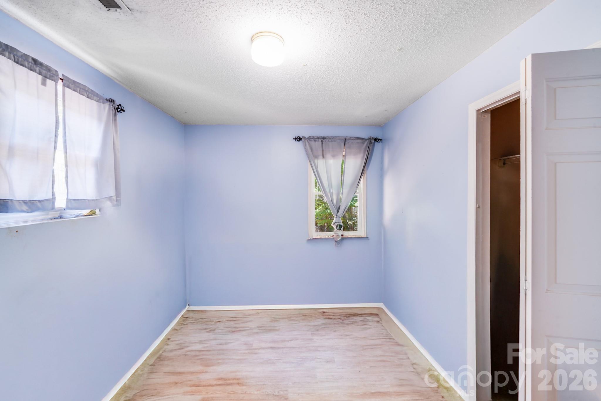 2116 Bon Villa Way Fort Mill, SC 29708 - Photo 21 of 28 a view of an empty room with window and wooden floor