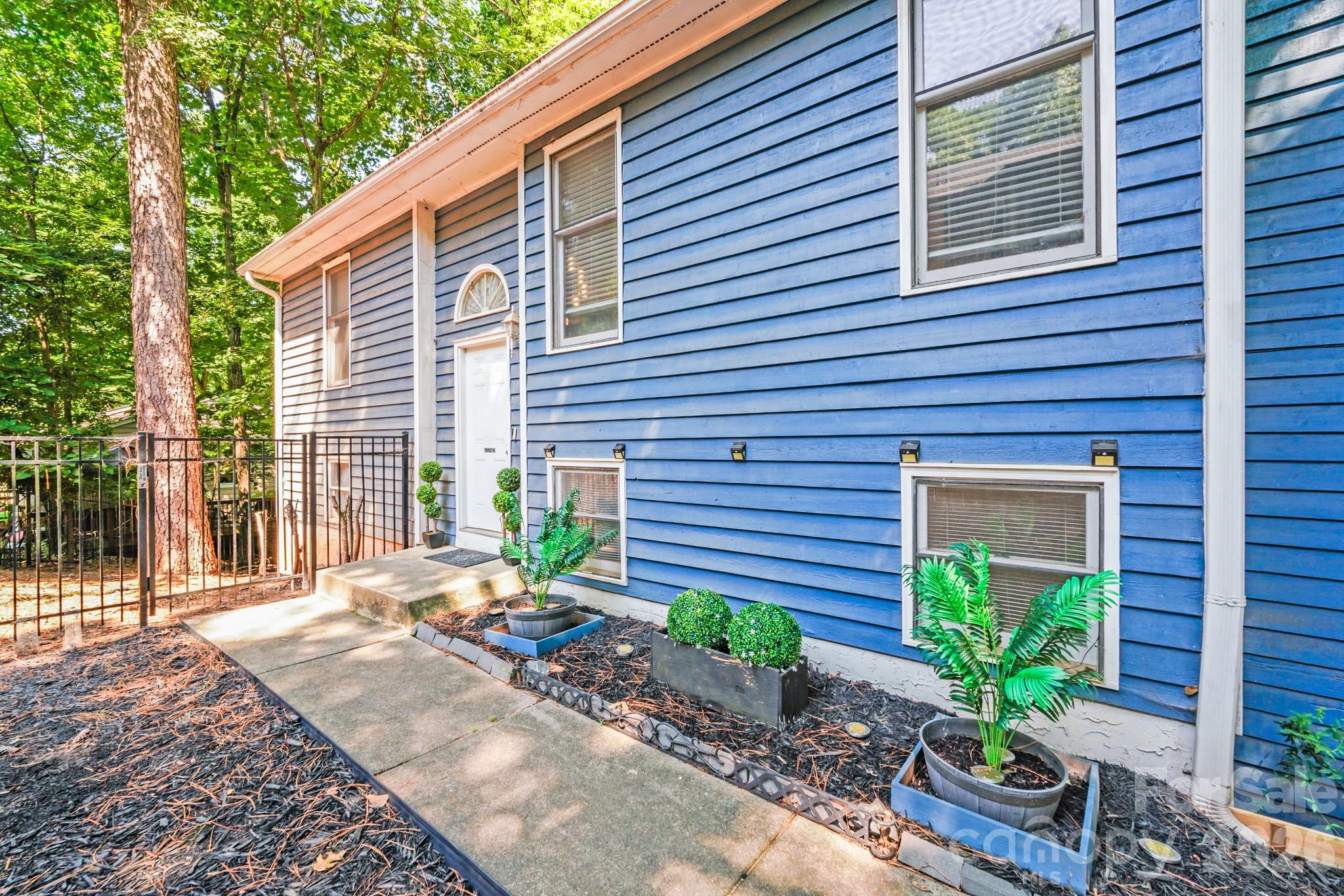 2116 Bon Villa Way Fort Mill, SC 29708 - Photo 23 of 28 a potted plant sitting in front of a house