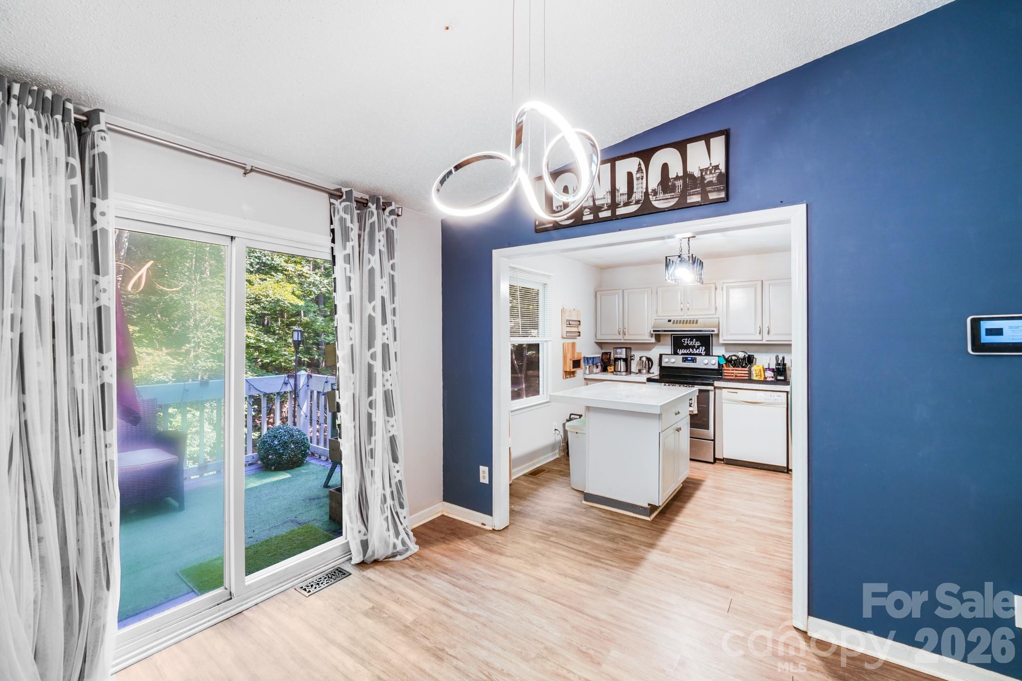2116 Bon Villa Way Fort Mill, SC 29708 - Photo 7 of 28 a open kitchen with a refrigerator a stove top oven and a large window