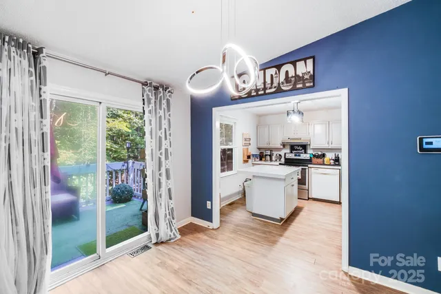 a living room with furniture kitchen view and a refrigerator