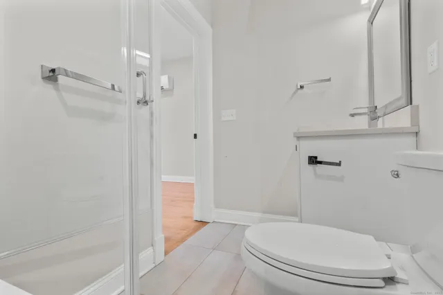 a bathroom with a toilet and a shower