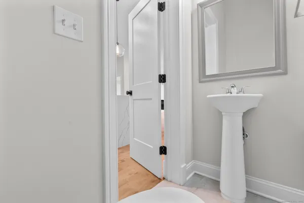 a bathroom with a sink and mirror with toilet