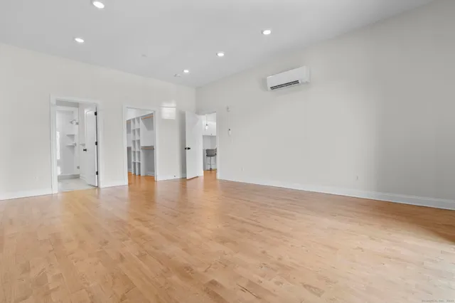 a view of an empty room with wooden floor