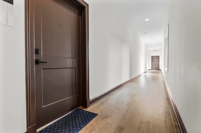 a view of hallway with wooden floor