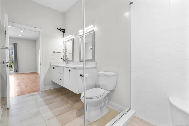 a bathroom with a toilet sink and a mirror