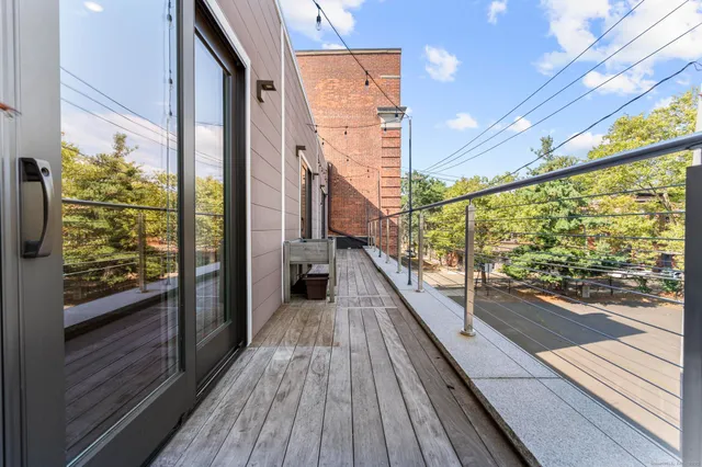 a view of a balcony with wooden floor