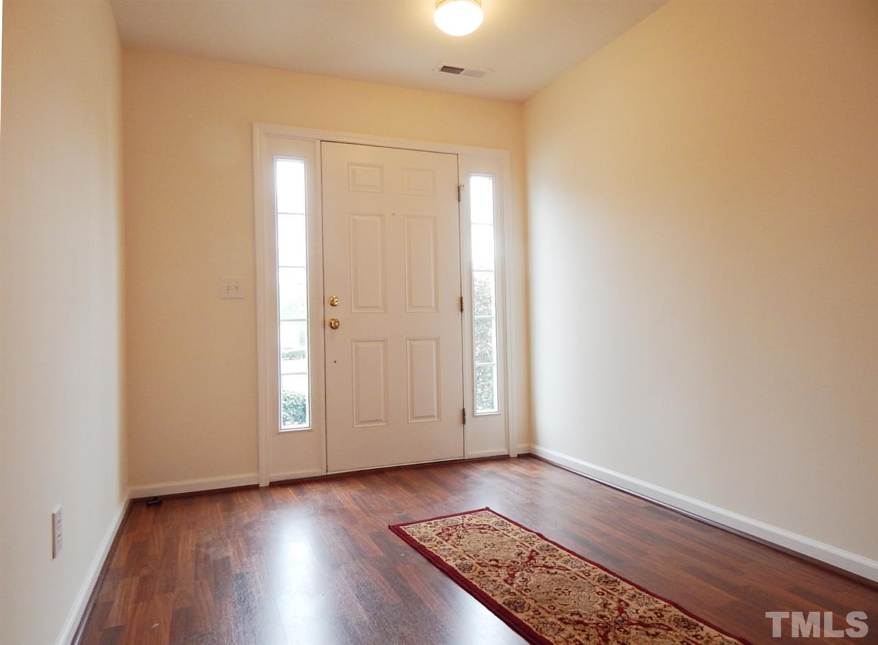 5051 Neuse Commons Lane Raleigh, NC 27616 - Photo 2 of 23 an empty room with wooden floor and window