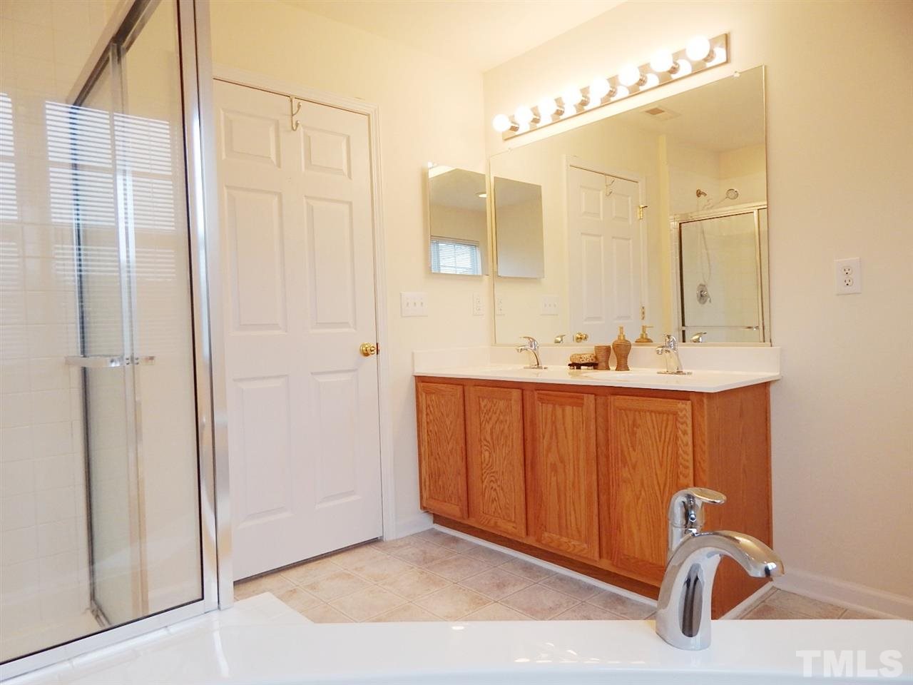 5051 Neuse Commons Lane Raleigh, NC 27616 - Photo 14 of 23 a bathroom with a sink and a mirror