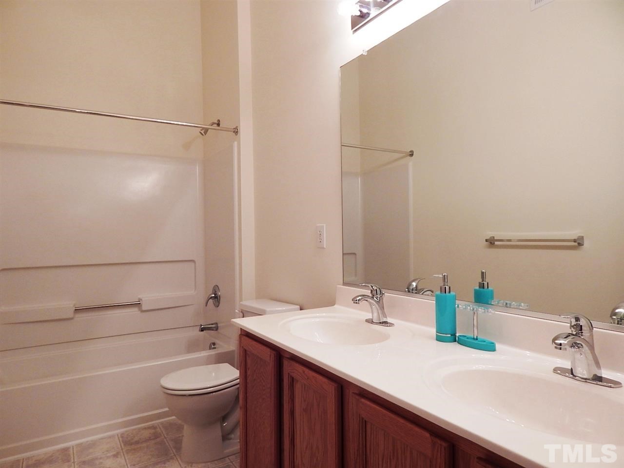 5051 Neuse Commons Lane Raleigh, NC 27616 - Photo 15 of 23 a bathroom with a sink a toilet and shower