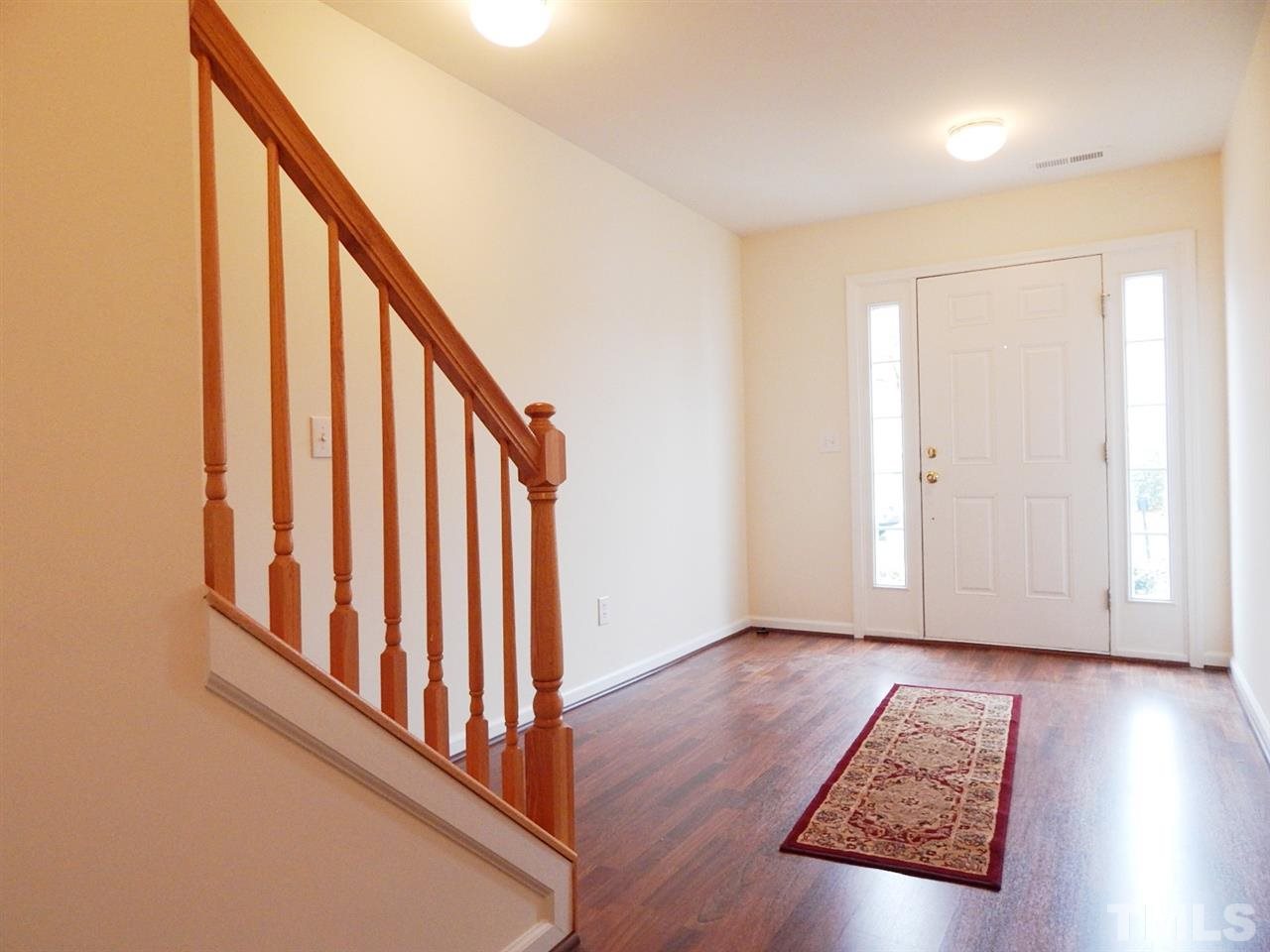 5051 Neuse Commons Lane Raleigh, NC 27616 - Photo 3 of 23 a view of staircase with wooden floor and stairs