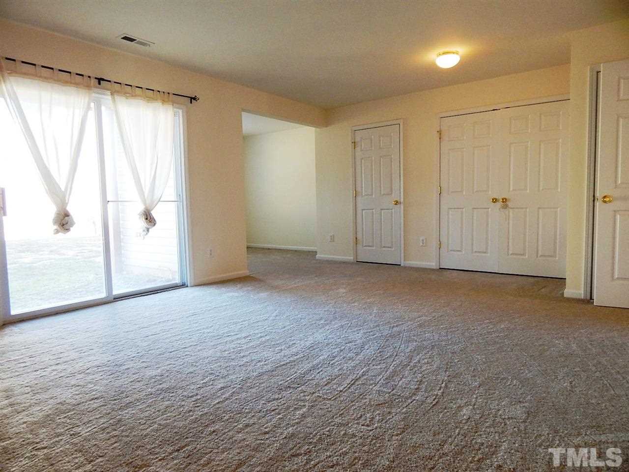 5051 Neuse Commons Lane Raleigh, NC 27616 - Photo 4 of 23 a view of an empty room with a window
