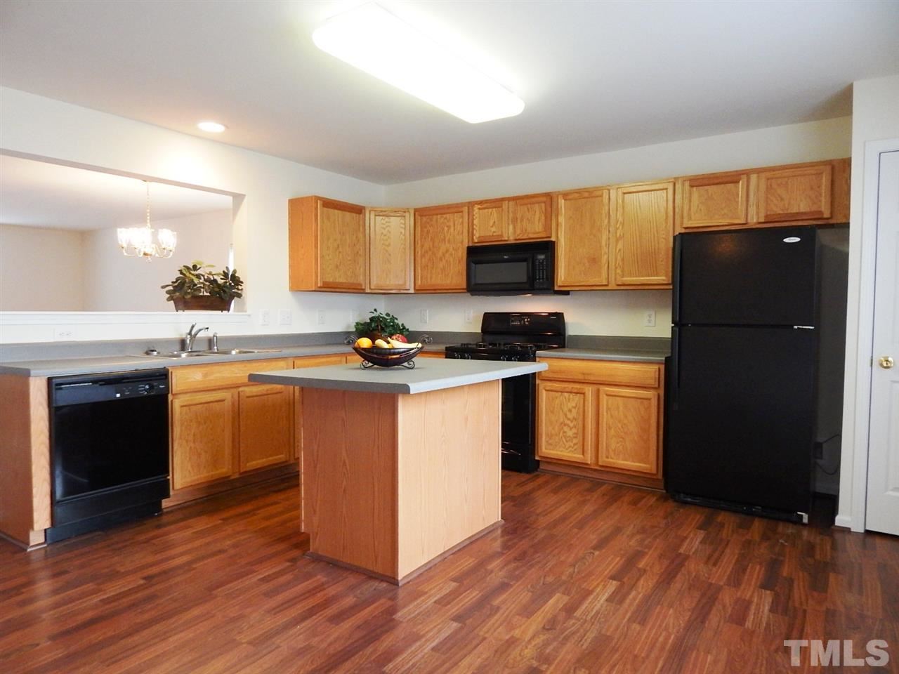 5051 Neuse Commons Lane Raleigh, NC 27616 - Photo 5 of 23 a kitchen with granite countertop a refrigerator stove top oven and sink