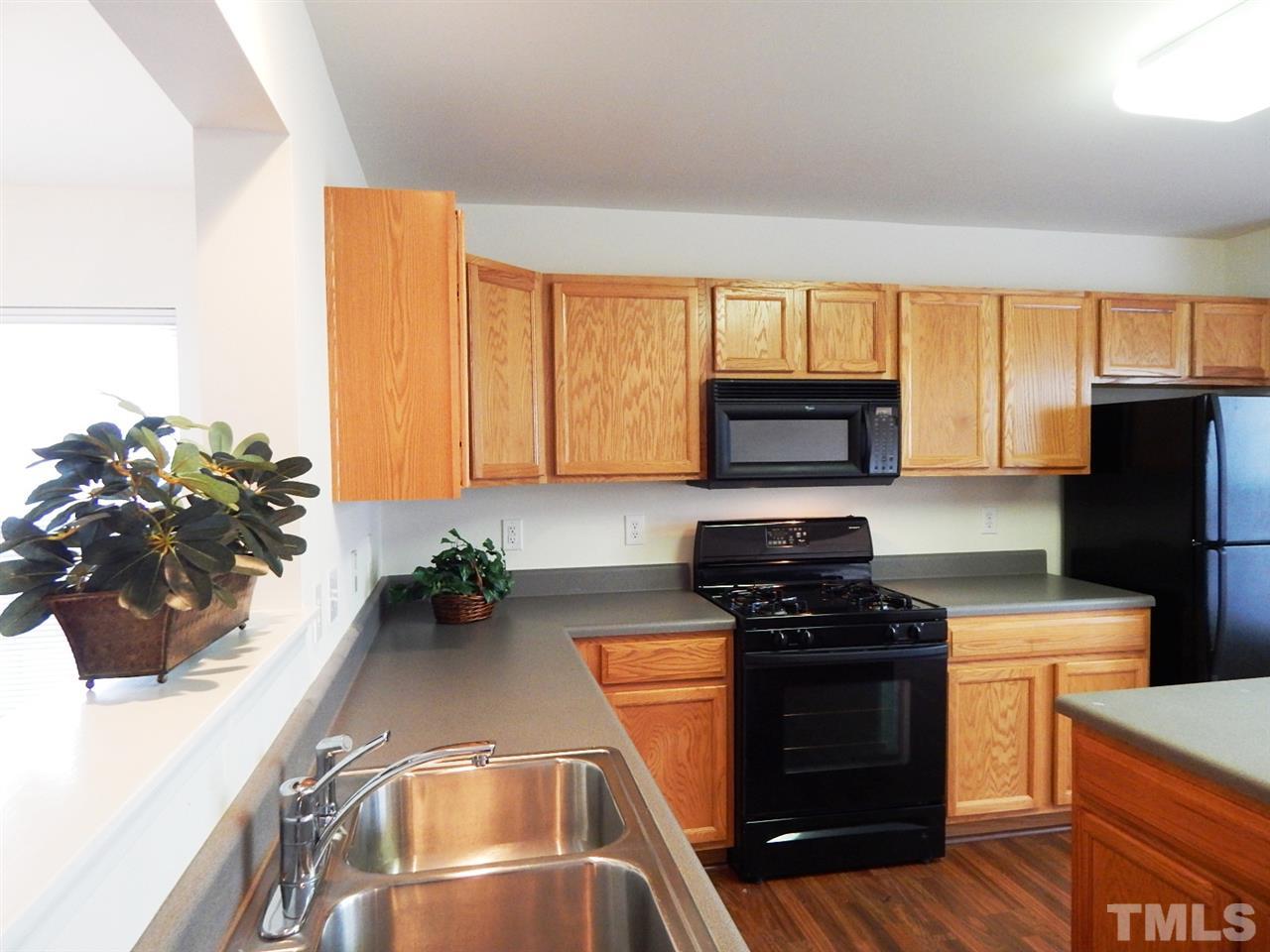 5051 Neuse Commons Lane Raleigh, NC 27616 - Photo 7 of 23 a kitchen with a sink appliances and cabinets