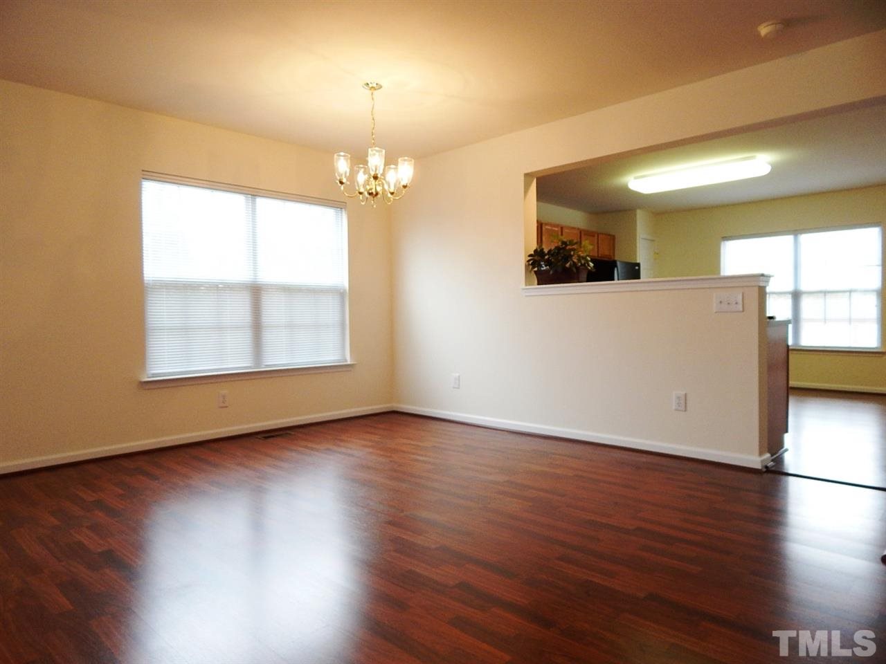 5051 Neuse Commons Lane Raleigh, NC 27616 - Photo 9 of 23 an empty room with wooden floor and windows