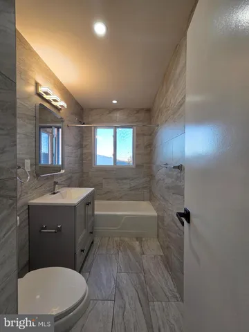 a bathroom with a sink a toilet and bathtub