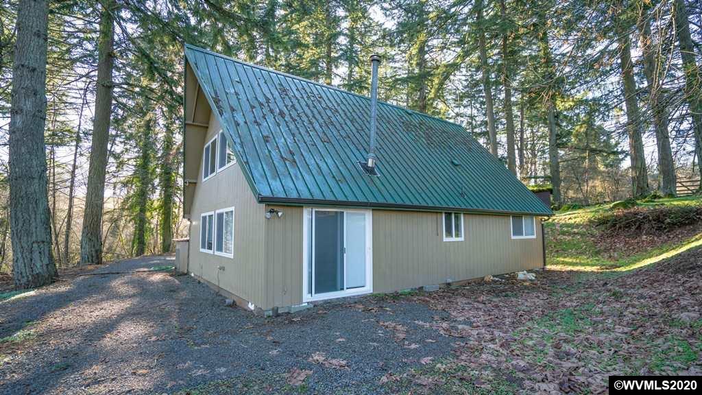 2401 Cole Road South Salem, OR 97306 - Photo 39 of 42 a backyard of a house with large trees and a barn