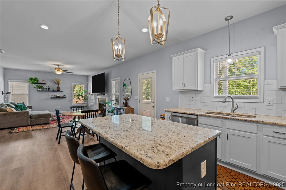 125 Solomon Drive Cameron, NC 28326 - Photo 14 of 49 a kitchen with center island table and chairs in it