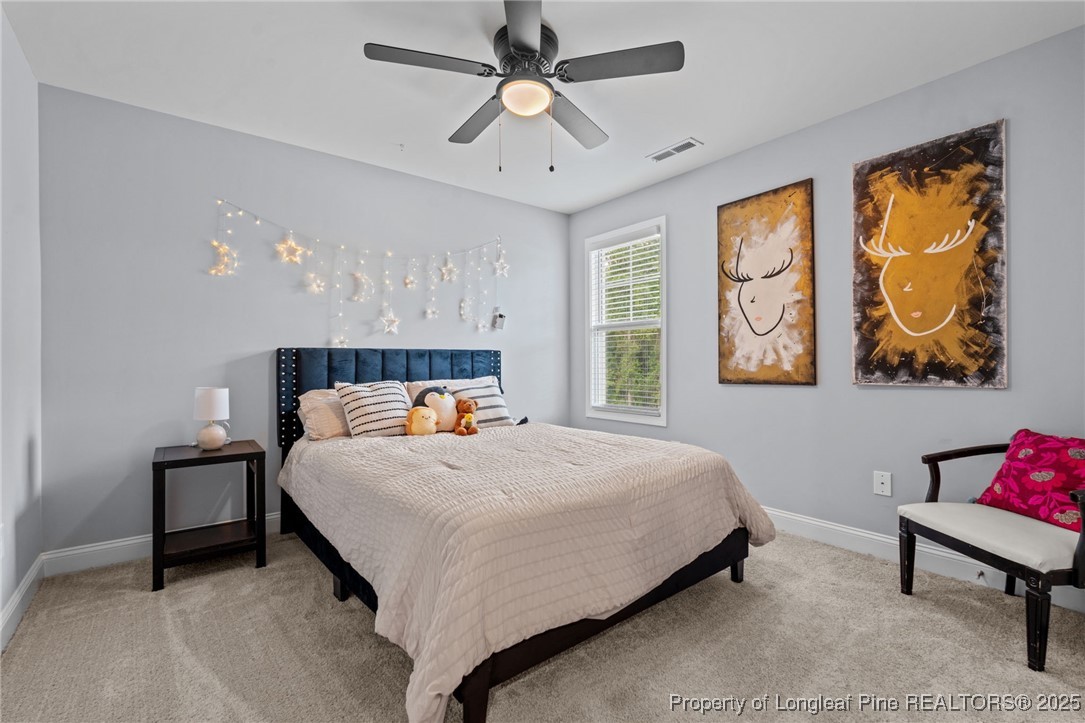 125 Solomon Drive Cameron, NC 28326 - Photo 21 of 49 a bedroom with a bed couch painting on the wall and a window