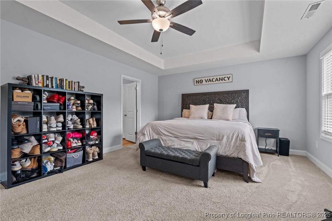 125 Solomon Drive Cameron, NC 28326 - Photo 25 of 49 a bedroom with bed and a chandelier