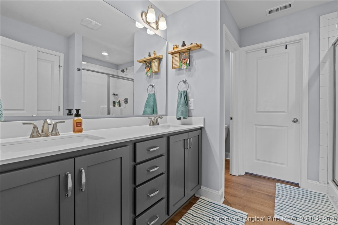125 Solomon Drive Cameron, NC 28326 - Photo 26 of 49 a bathroom with double vanity and a mirror
