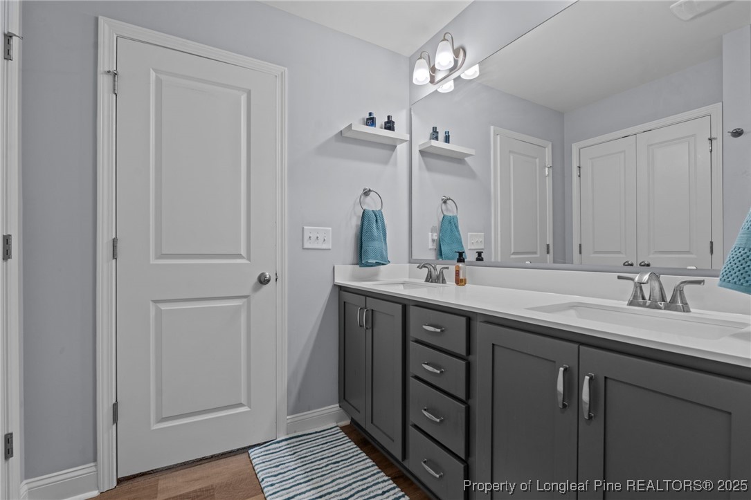 125 Solomon Drive Cameron, NC 28326 - Photo 29 of 49 a bathroom with a double vanity sink and a mirror