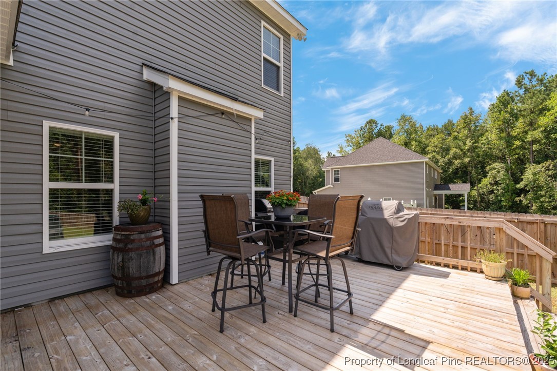 125 Solomon Drive Cameron, NC 28326 - Photo 31 of 49 a view of a deck with table and chairs floor to ceiling window with wooden floor