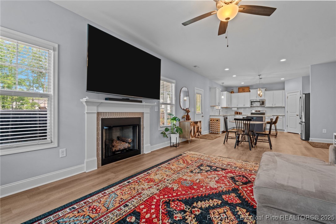 125 Solomon Drive Cameron, NC 28326 - Photo 8 of 49 a living room with furniture a flat screen tv and a fireplace