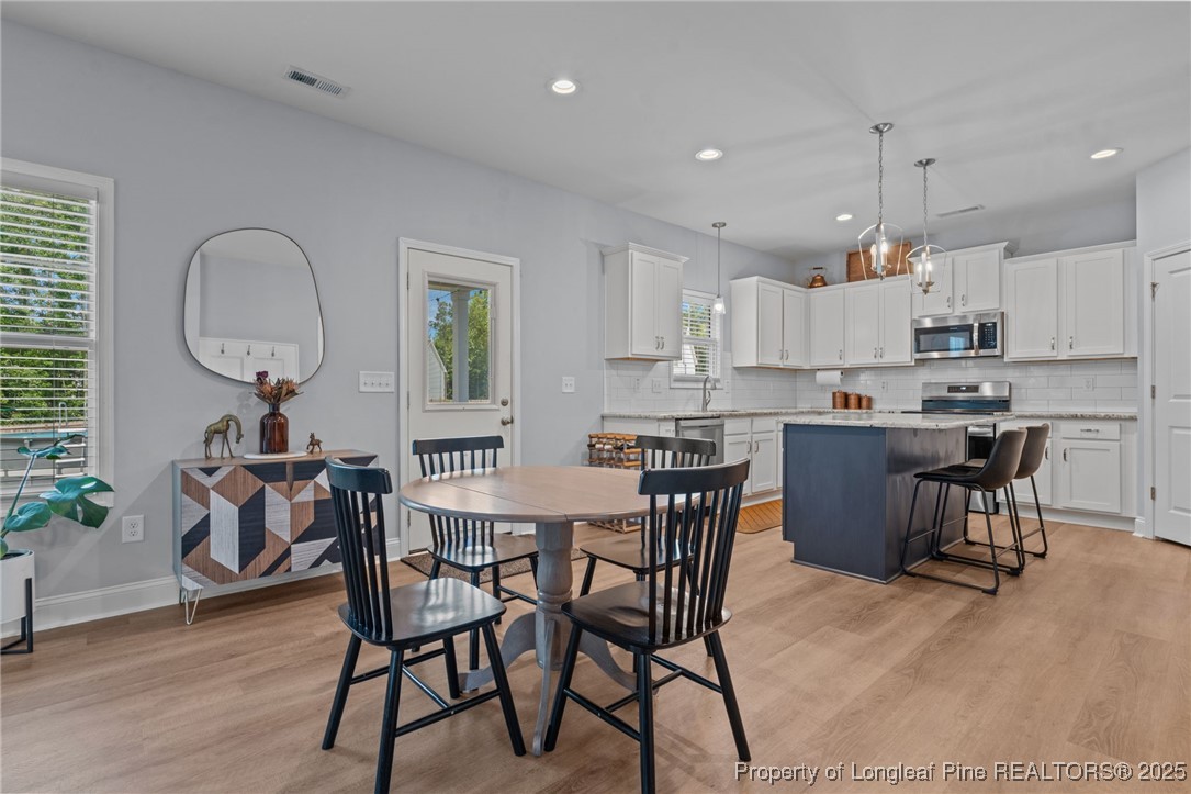 125 Solomon Drive Cameron, NC 28326 - Photo 9 of 49 a view of a dining room with furniture window and wooden floor