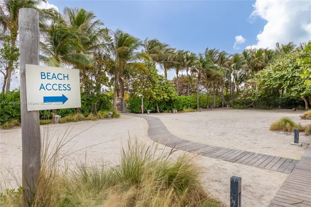 a view of a patio with table and chairs potted plants and large tree