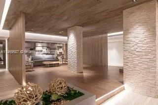 a view of a hallway with wooden floor and a living room