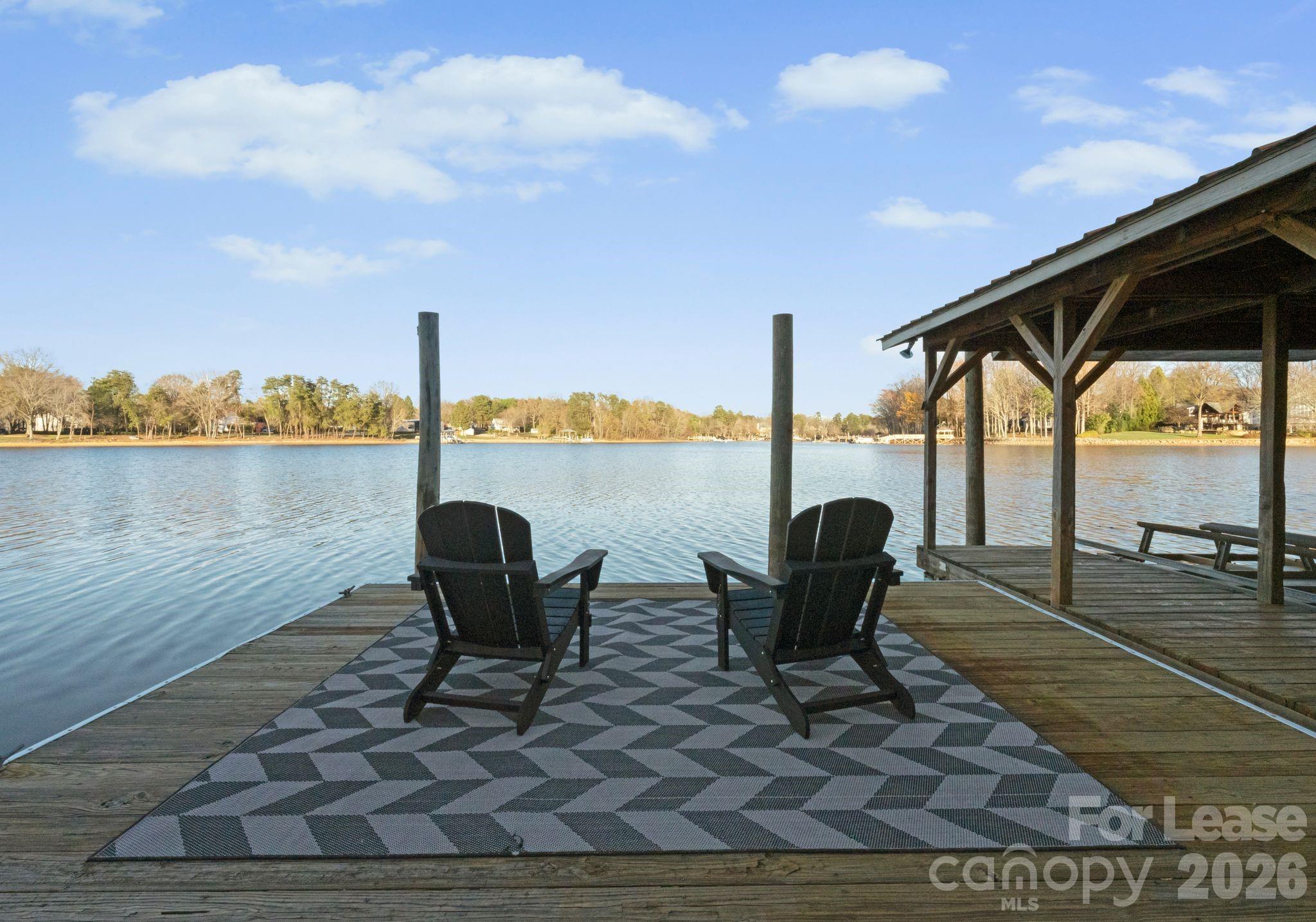 19709 Stough Farm Road Cornelius, NC 28031 - Photo 41 of 48 a view of a lake with a table and chairs