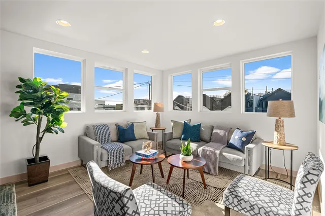 a living room with furniture potted plant and window