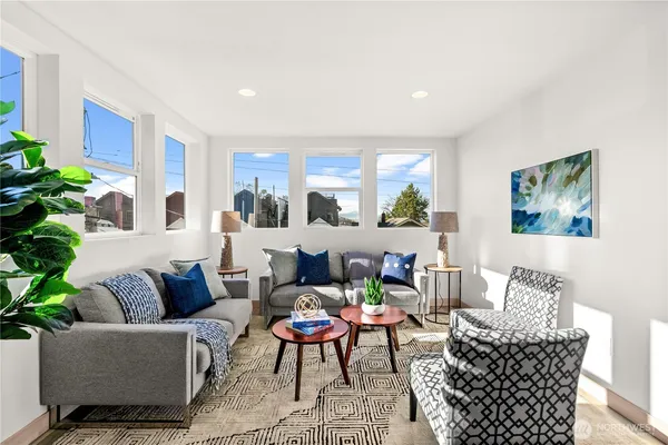 a living room with furniture and a potted plant