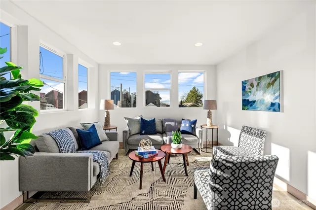 a living room with furniture and a potted plant