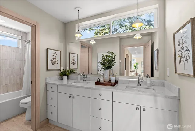 a bathroom with a sink a large mirror and a bathtub