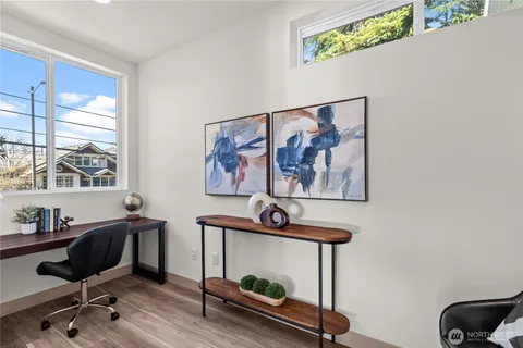 a view of a workspace with furniture and a window