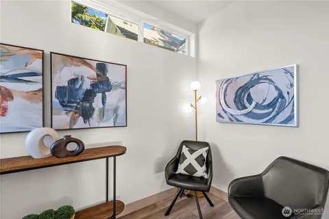 a view of a hallway with paintings on the wall