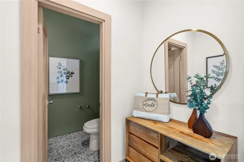 a living room with a toilet and a mirror