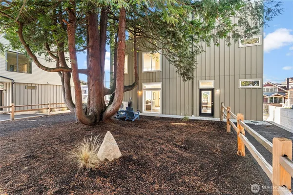a view of a house with backyard and sitting area